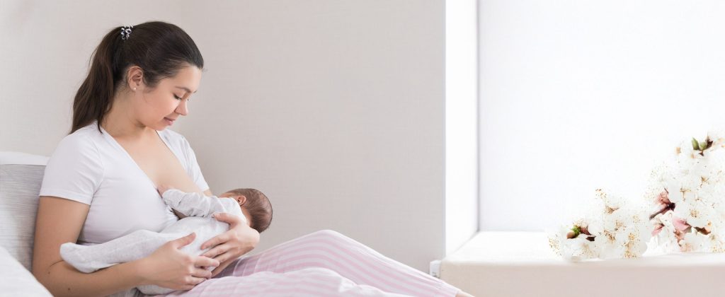 woman breastfeeding a toddler